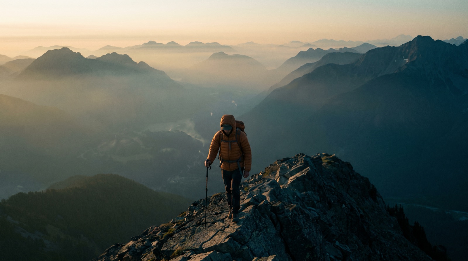 A lone hiker carefully descending a mountain ridge at dawn, a still from the education film The Descent.